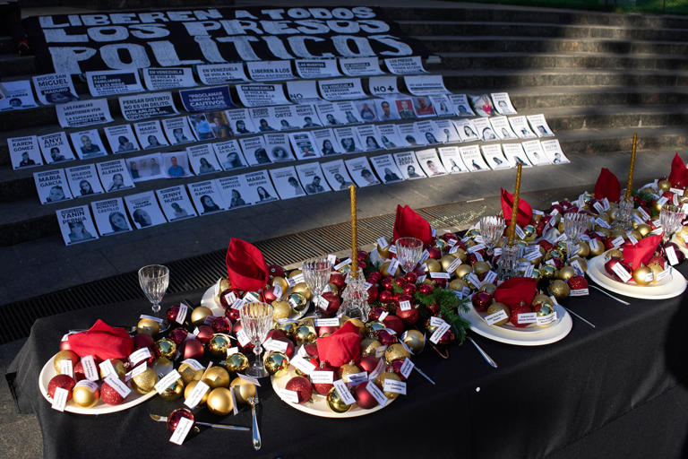 A table is set with plates and Christmas decorations in Caracas bearing the names of people considered by rights groups to be political prisoners.