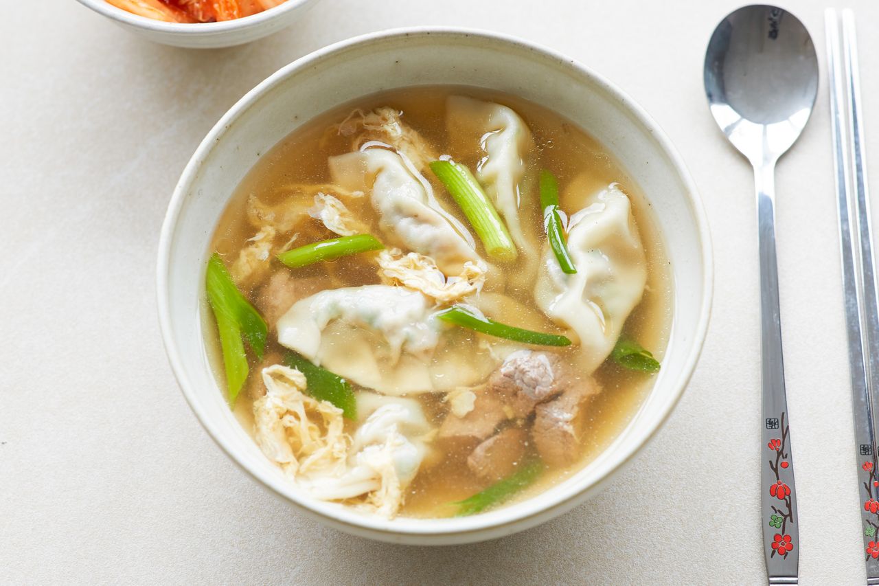 Overhead view of a bowl of beef soup with dumplings.