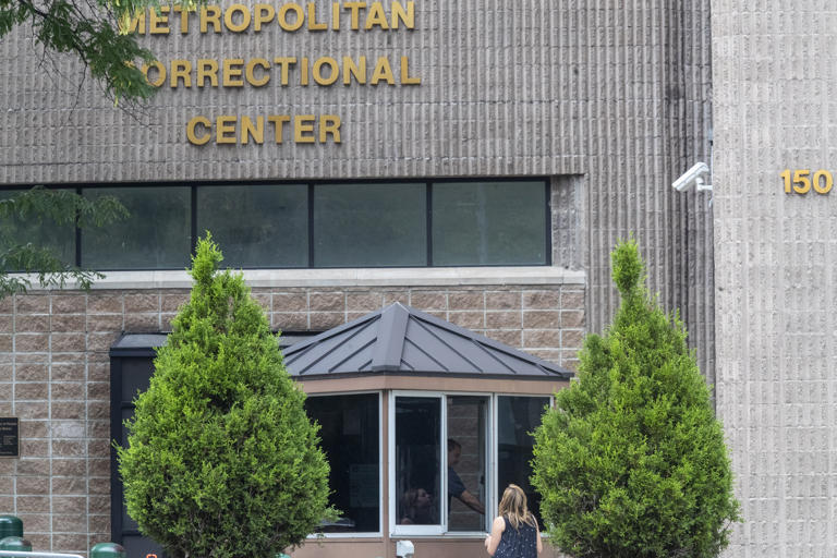 An employee checks a visitor outside the Metropolitan Correctional Center in 2019.
