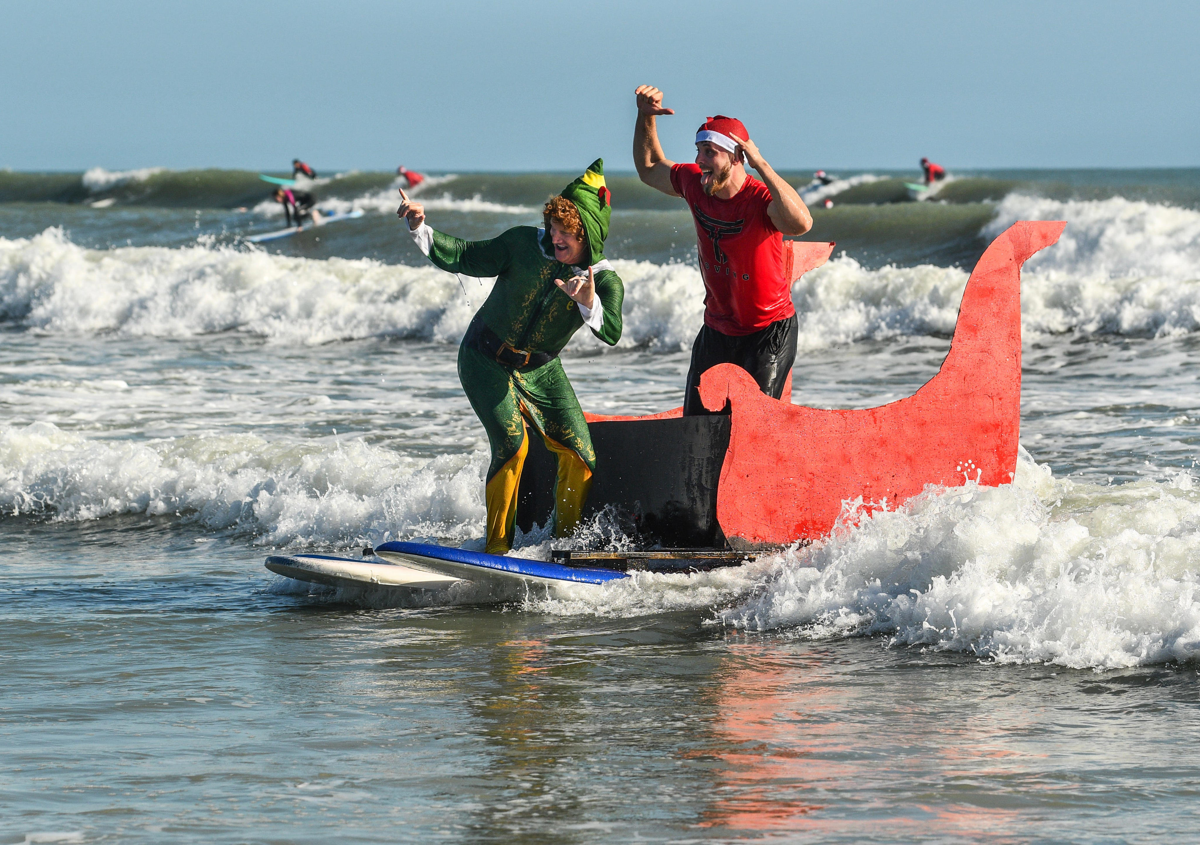 Surfing Santas ride festive holiday wave in photo of the week