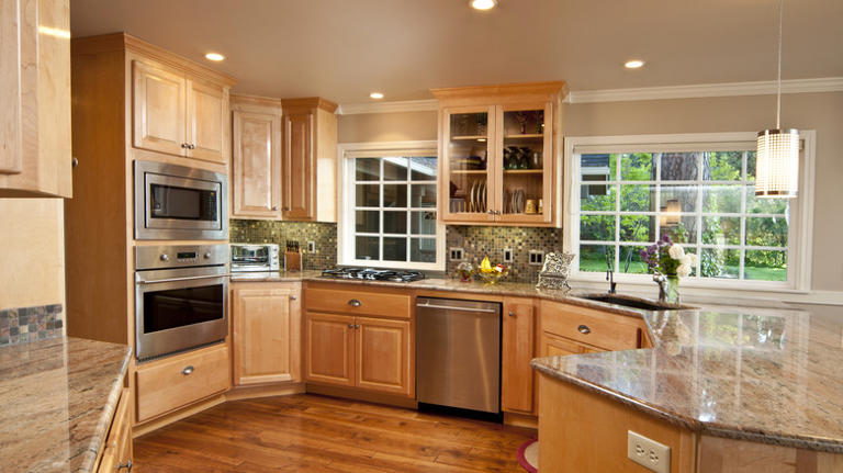 The clever lighting tip that'll update orange cabinets without touching ...