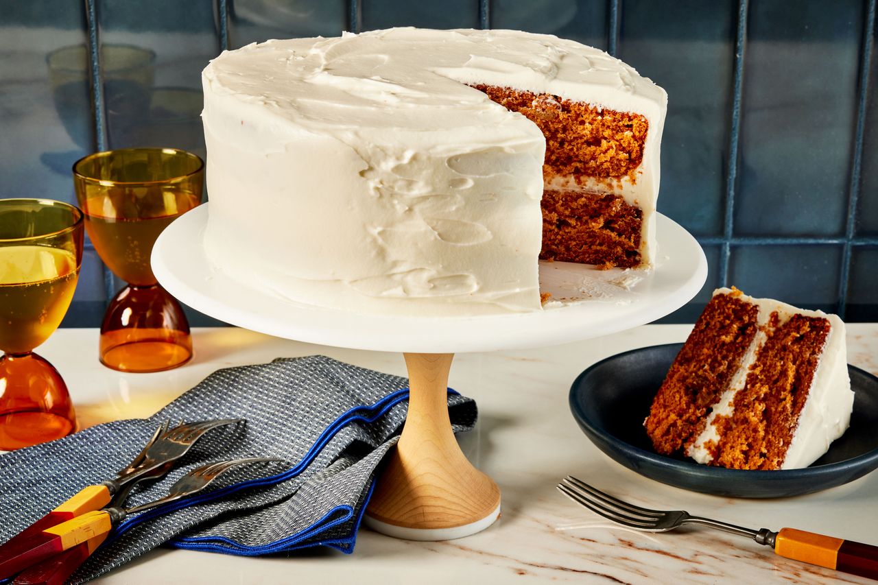 Southern Living Tomato Soup Cake on a cake plate with a slice cut on a plate beside