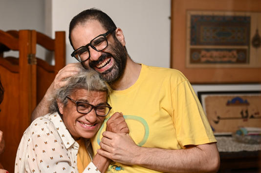 Alaa and his mother are reunited with family in the UK (Picture: Getty)