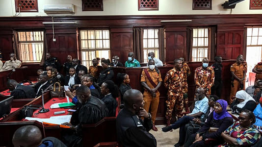 Uganda's veteran opposition leader Kizza Besigye, center rear, appears at High Court, in Kampala, Uganda, Monday, Dec. 29 2025. (AP Photo/Hajarah Nalwadda)