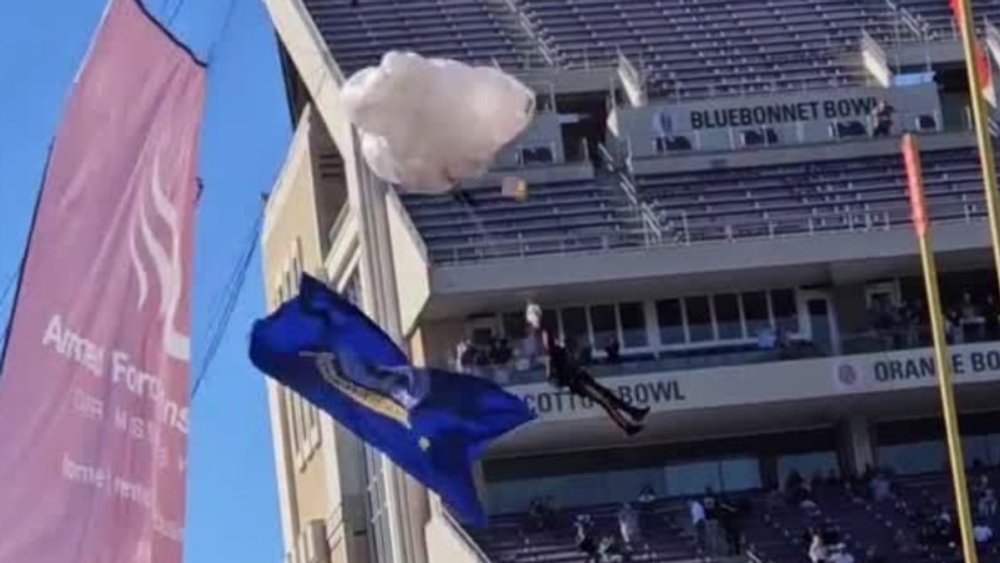 Shock before football game: Skydiver gets caught in rope