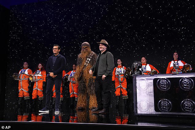 Asad Ayaz (left) and Dave Filioni (right) on stage with a Chewbacca during a Lego news conference in Las Vegas today. The first smart bricks will be part of Lego's Star Wars building sets and will be launched on March 1 this year 