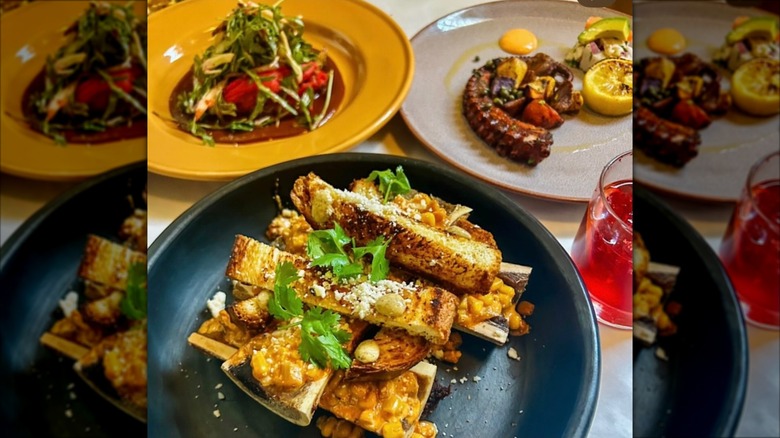 Assortment of dishes including octopus on colorful plates