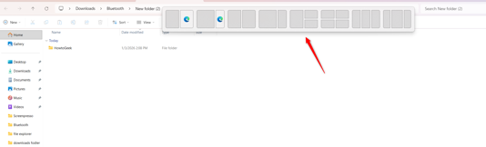 Using the Snap Layouts feature in File Explorer.