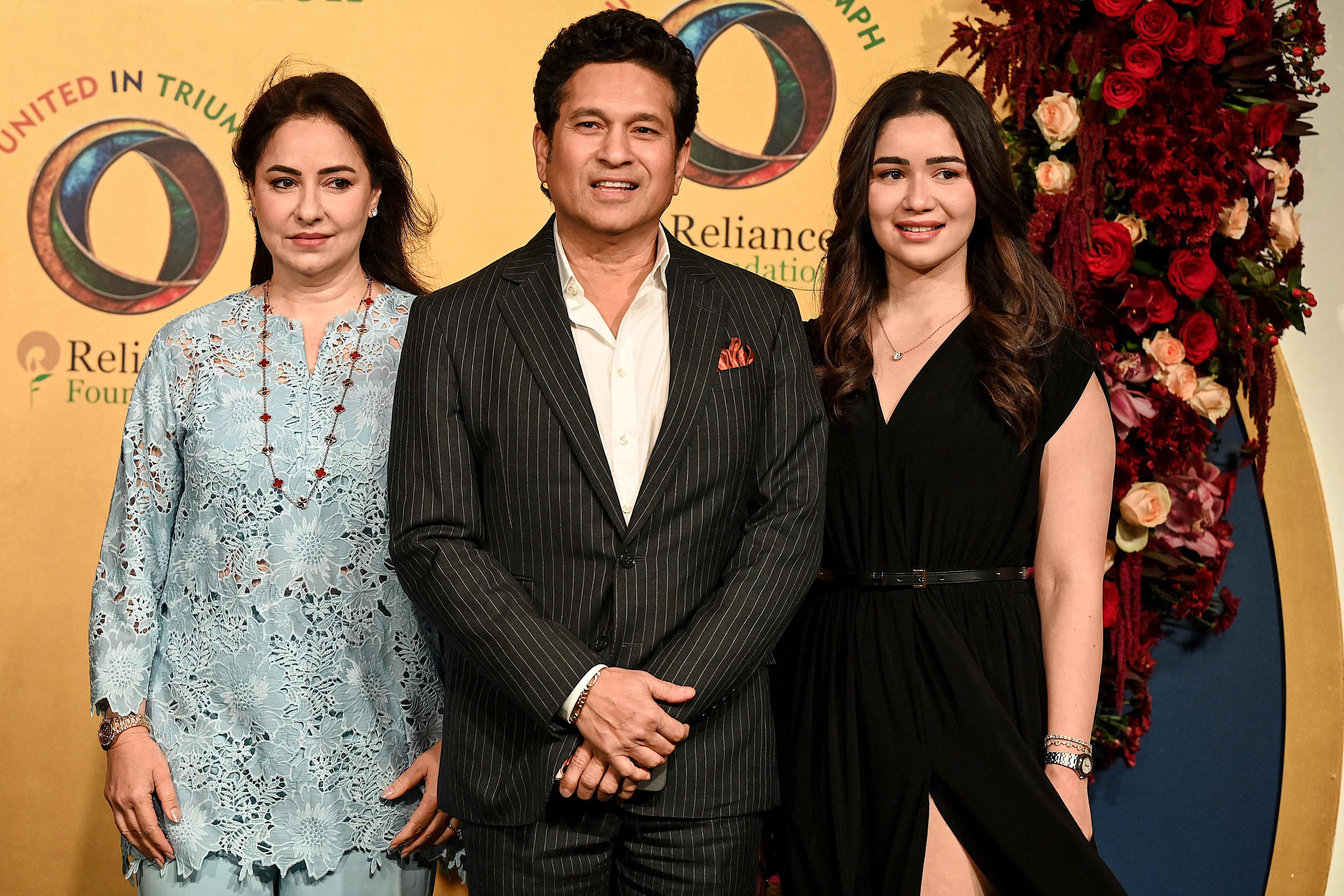 Indian former cricket player Sachin Tendulkar (C), his wife Anjali Tendulkar (L) and daughter Sara Tendulkar attend the United in Triumph felicitation event hosted by Reliance Foundation to honour the country's national cricket teams in Mumbai on January 5, 2026. (Photo by Sujit JAISWAL / AFP)