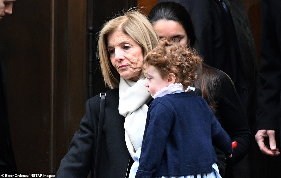 Caroline Kennedy holds baby Josephine at daughter's funeral