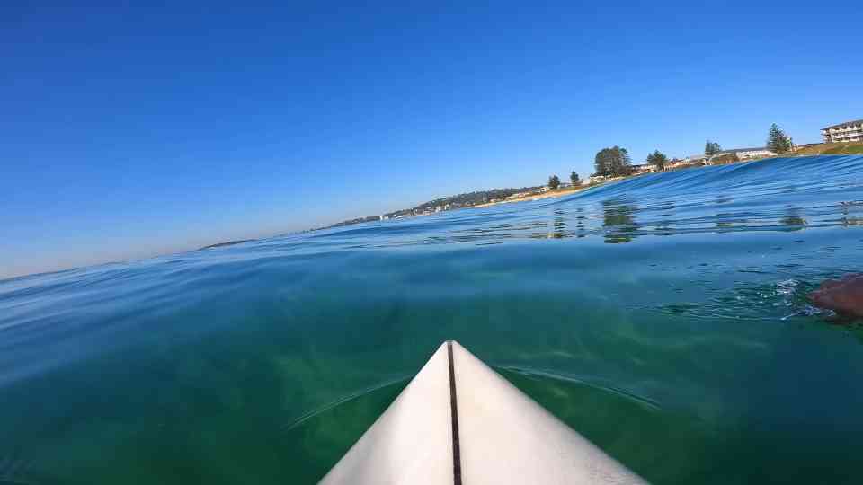 He paddled out alone and the ocean went silent before firing