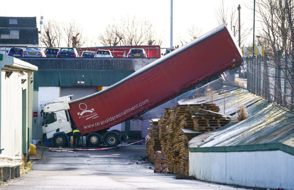 HGV smashed through fence and fell 15ft into service yard