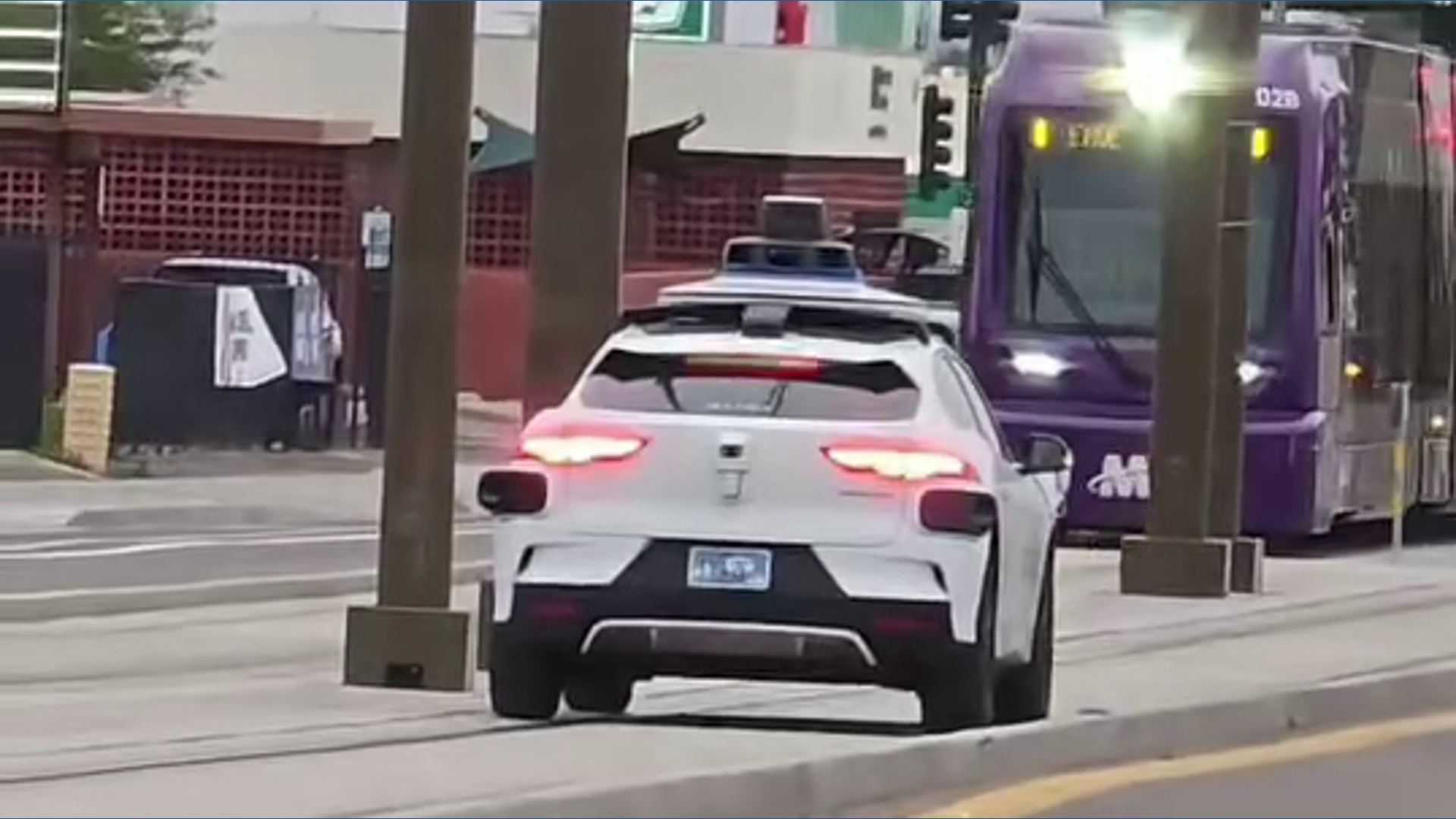 Waymo car seen driving on light rail tracks in Phoenix