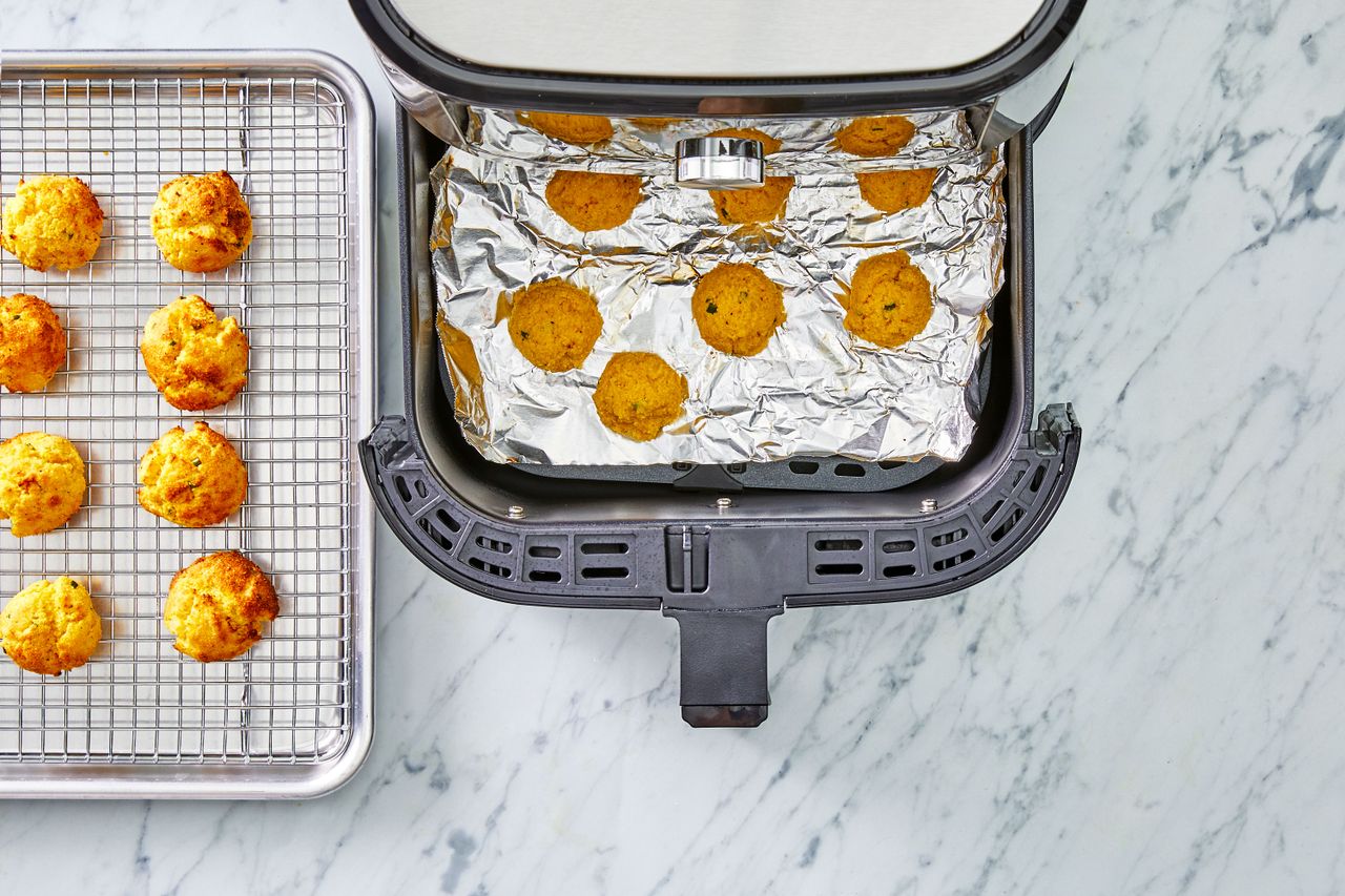 Southern Living Air Fryer Hush Puppies transferring first batch to the oven