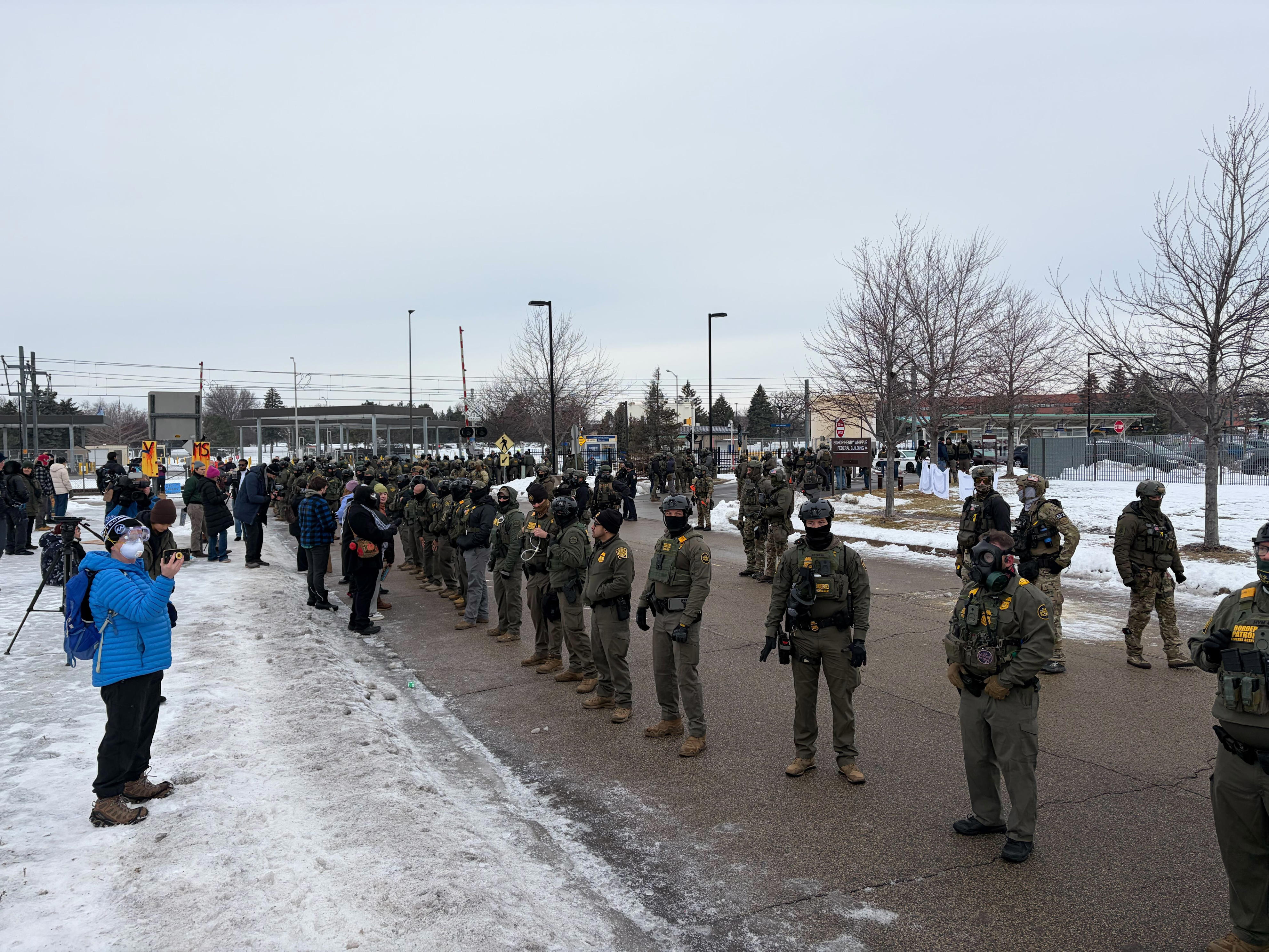 Federal officials and protesters clash briefly at Whipple Building at ...