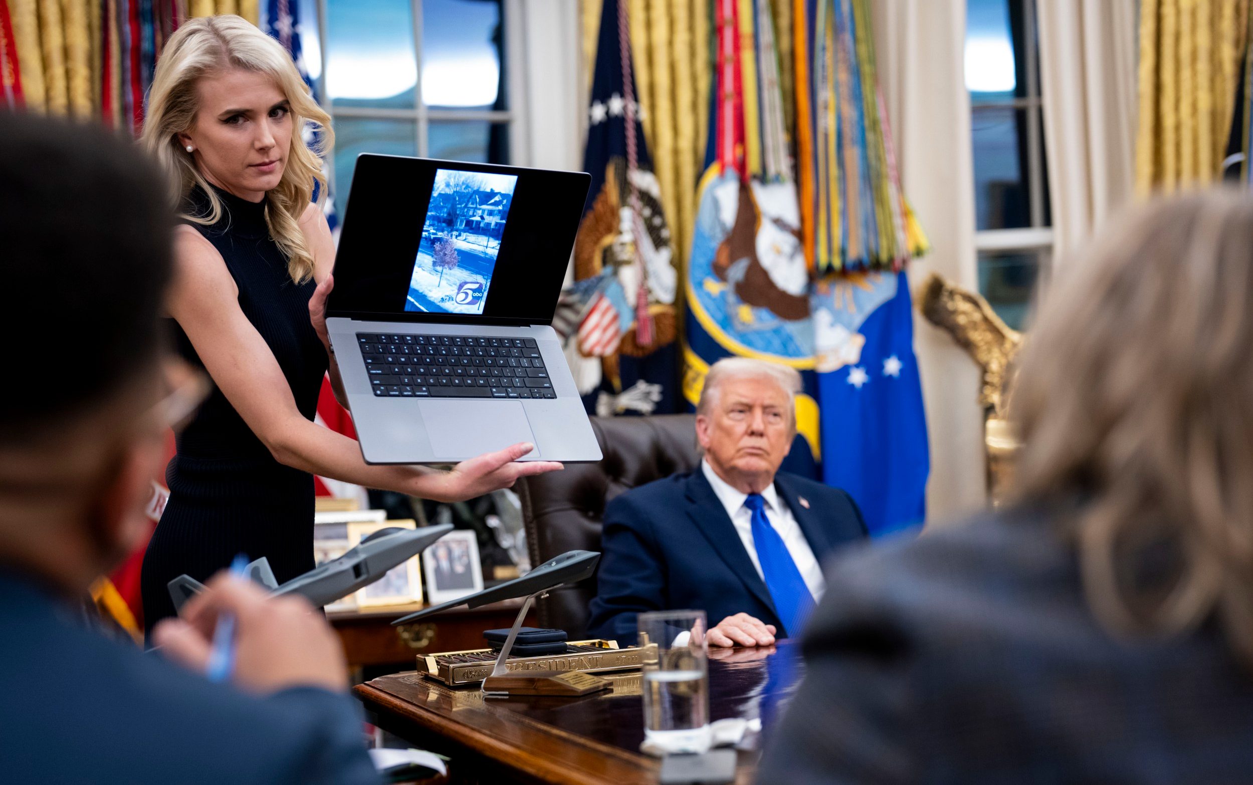 Natalie Harp, one of the president’s aides, shows a video of a shooting that took place in Minnesota on Wednesday - Doug Mills/ The New York Times