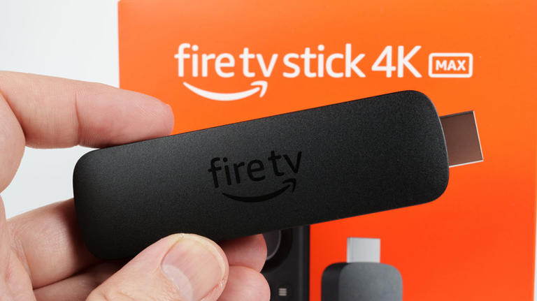A person holding up an Amazon Fire TV Stick.