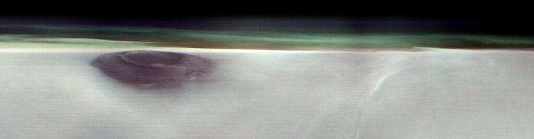 Arsia Mons, an ancient Martian volcano, was captured before dawn on May 2, 2025, by NASA&rsquo;s 2001 Mars Odyssey orbiter while the spacecraft was studying the Red Planet&rsquo;s atmosphere, which appears here as a greenish haze. Credit: NASA/JPL-Caltech/ASU