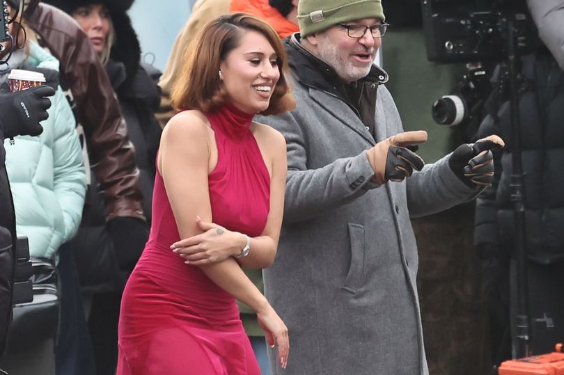 Raye braves the cold in sleeveless red dress and shows off dance moves ...