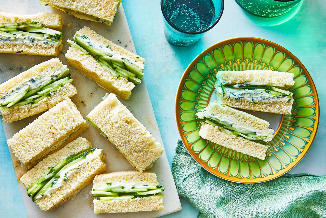 Southern Living Cucumber Tea Sandwiches on a serving platter with a small plate of sandwiches beside