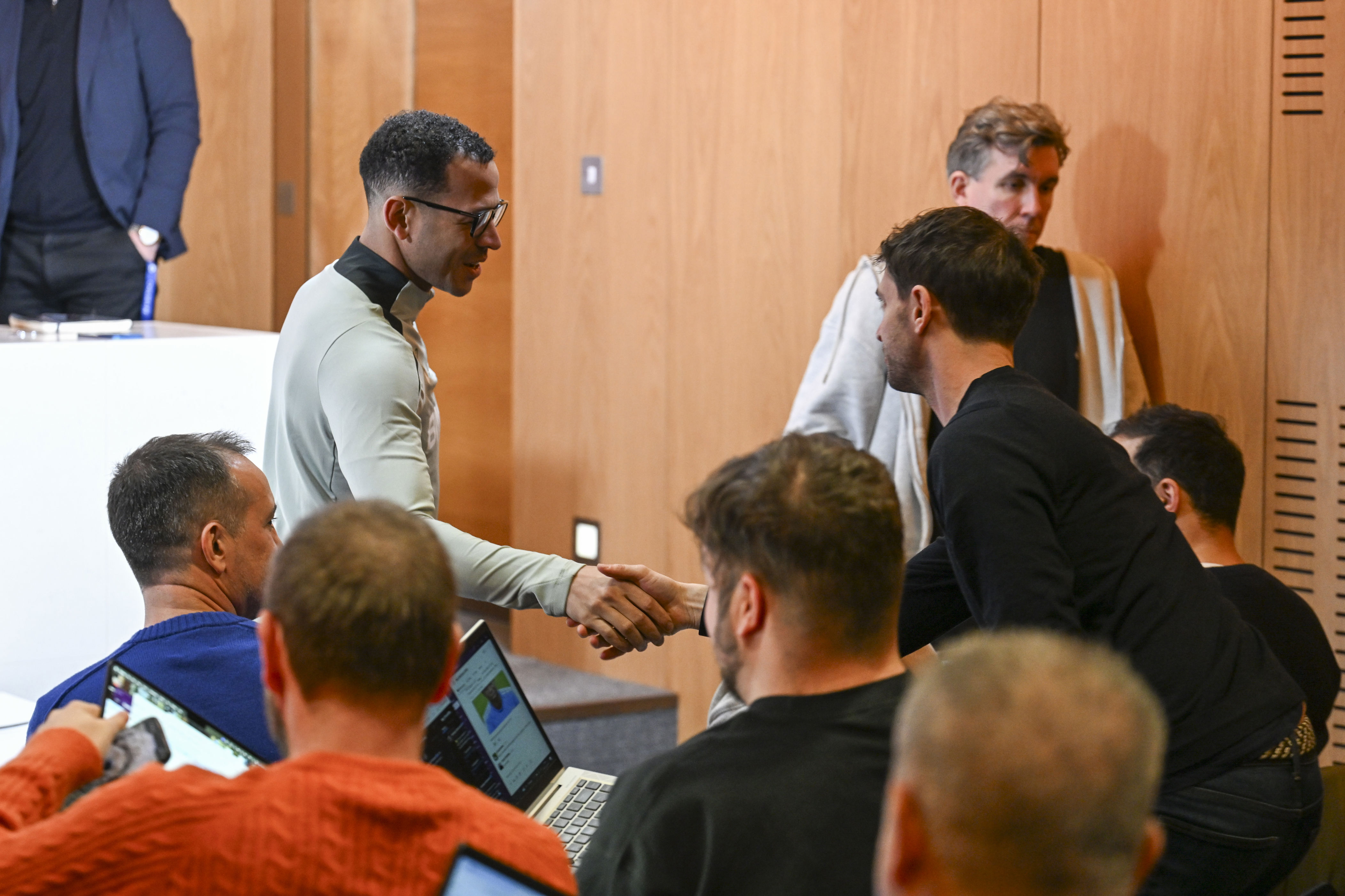 Liam Rosenior shook hands with journalists before his first Chelsea press conference (Chelsea FC via Getty Images)