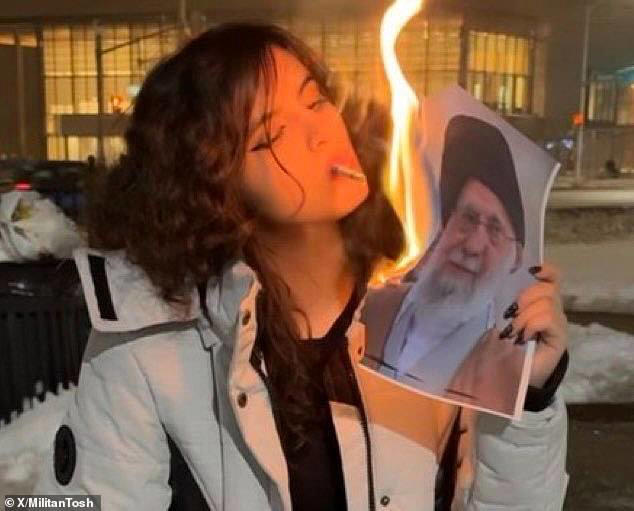 Women in Iran are lighting photos of Ayatollah Khamenei on fire