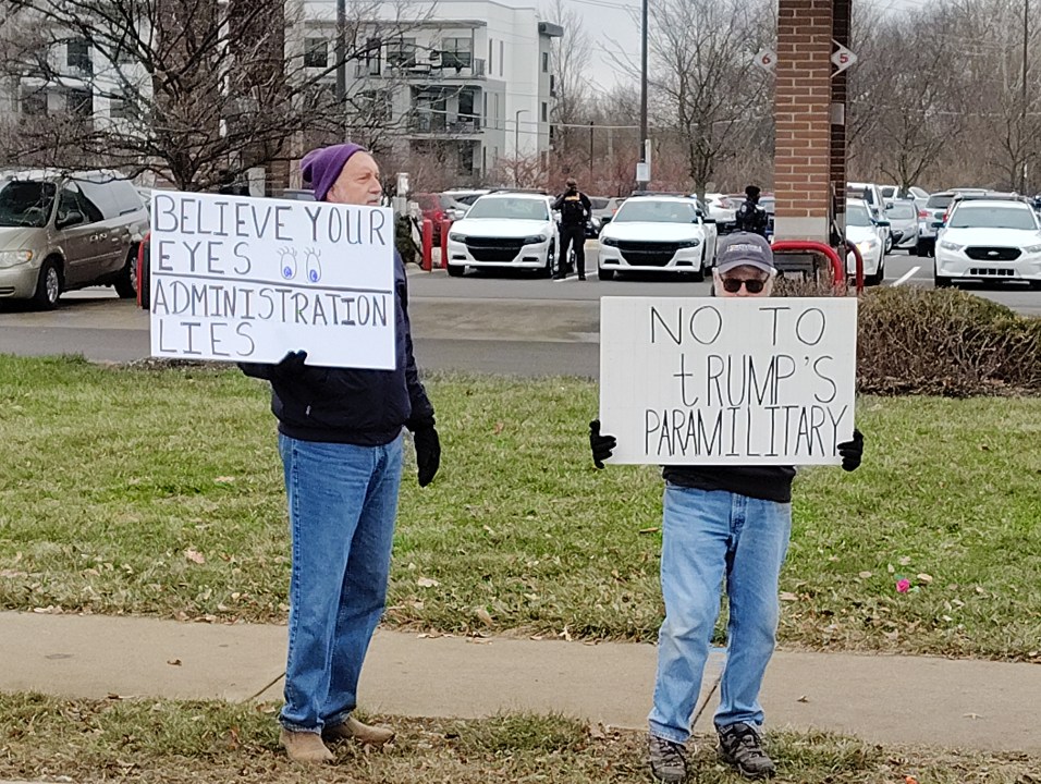 Anti-ICE protesters line 86th Street with signs
