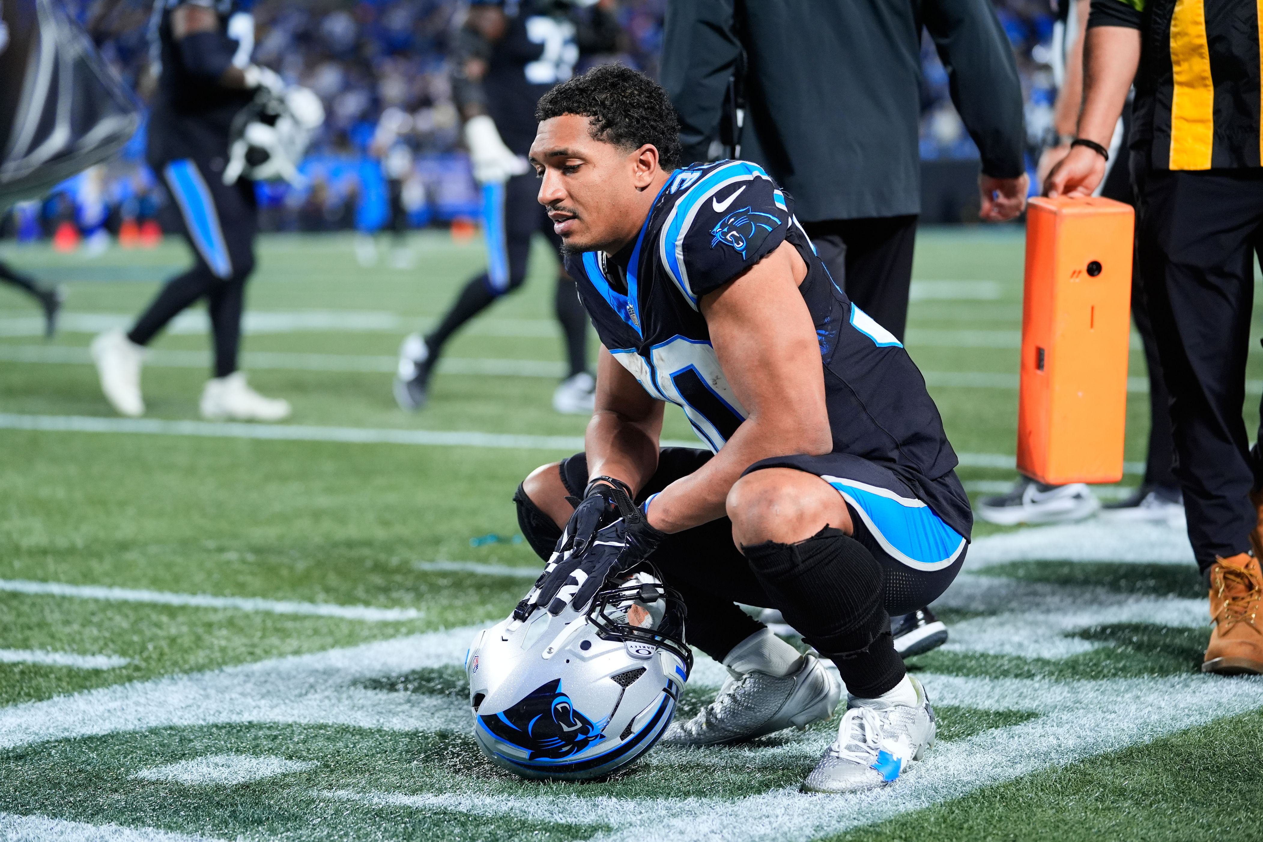 Carolina Panthers running back Chuba Hubbard (30) kneels on the field after a loss to the Los Angeles Rams in an NFL wild-card playoff football game, Saturday, Jan. 10, 2026, in Charlotte, N.C. (AP Photo/Erik Verduzco)