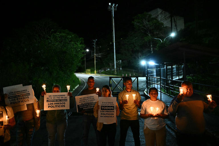 Relatives of political prisoners light candles during a vigil in demand of the release of their loved ones outside of El Rodeo I prison in Guatire, Miranda State, east of Caracas on Friday. (Ronaldo Schemidt / AFP via Getty Images)
