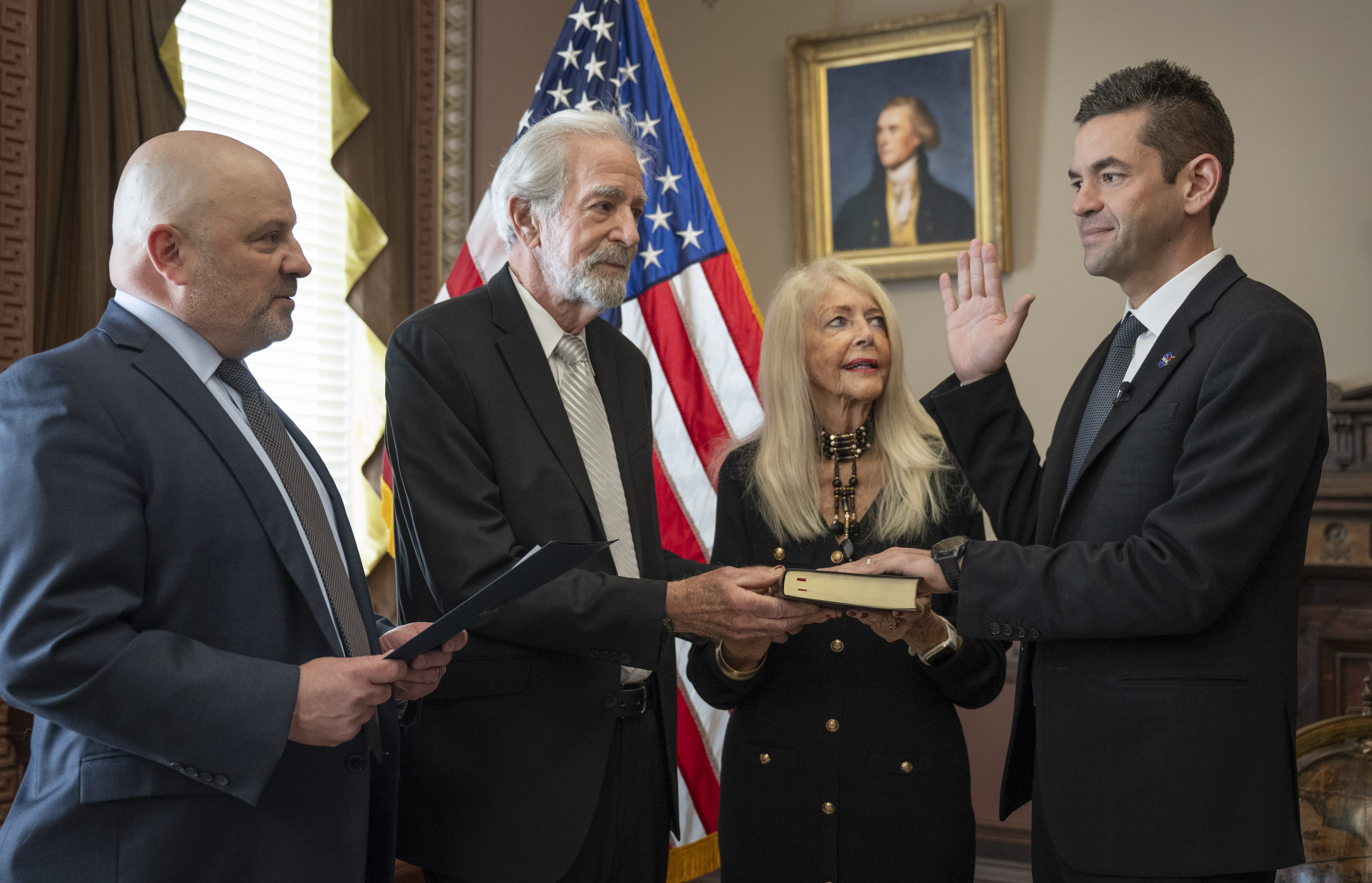 U.S. District Judge Timothy Kelly, left, swears in Jared Isaacman, right, as 15th administrator of NASA, as Isaacman's parents, Donald and Sandra Marie, watch at the Eisenhower Executive Office Building on Dec. 18, in Washington.