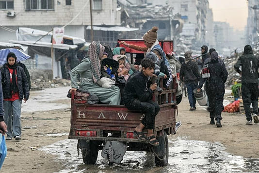 A Palestinian family rides on a cart amid the rain in Gaza City, Monday, Dec. 15, 2025. Jehad Alshrafi/Copyright 2025 The AP. All rights reserved.
