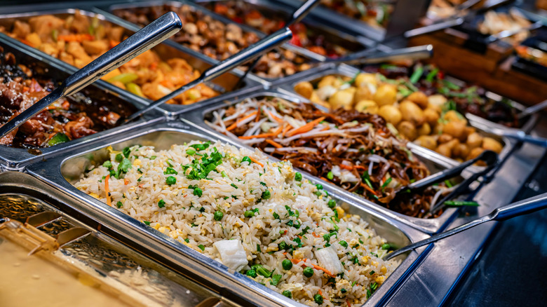Trays of Chinese food in a buffet serving station