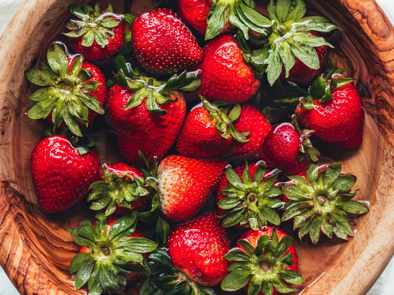 strawberries in a bowl of water
