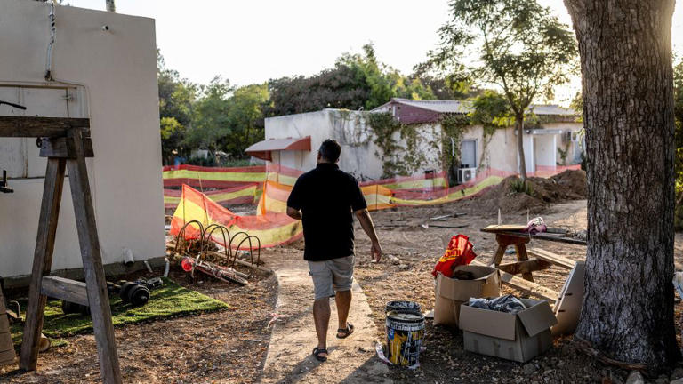 Avishay Edri, 41, walks on a path near the home he is returning to after he was evacuated following the October 7, 2023, attack in Kibbutz Nahal Oz in southern Israel, October 30, 2025. - Ronen Zvulun/Reuters
