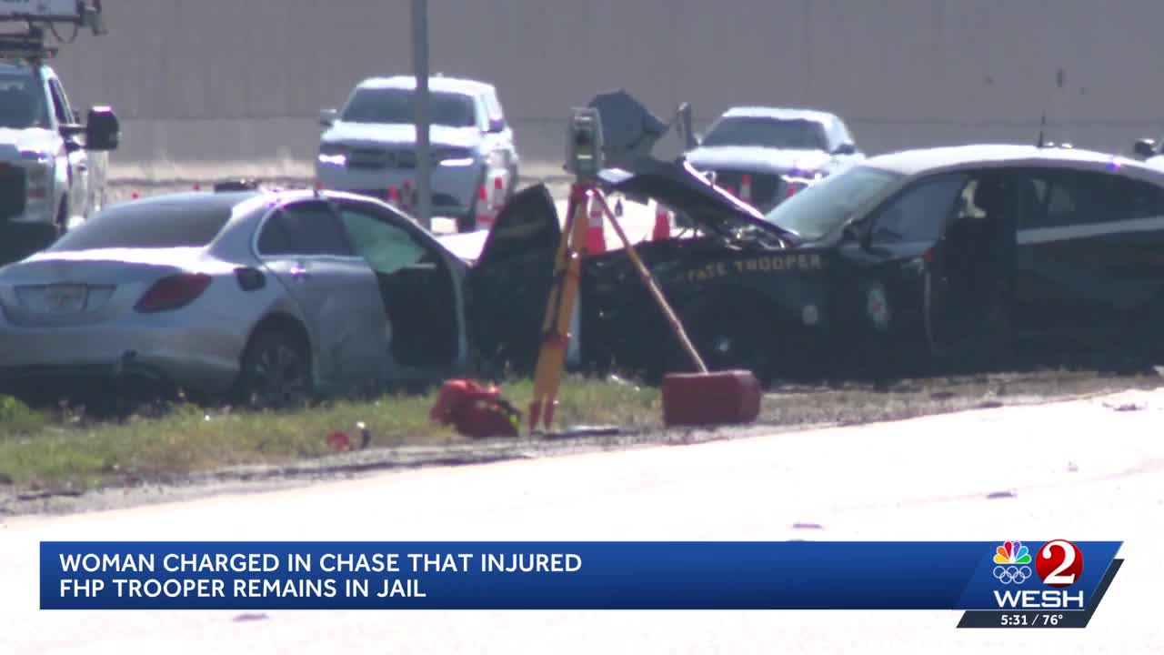 Woman charged in chase that injured FHP trooper remains in jail
