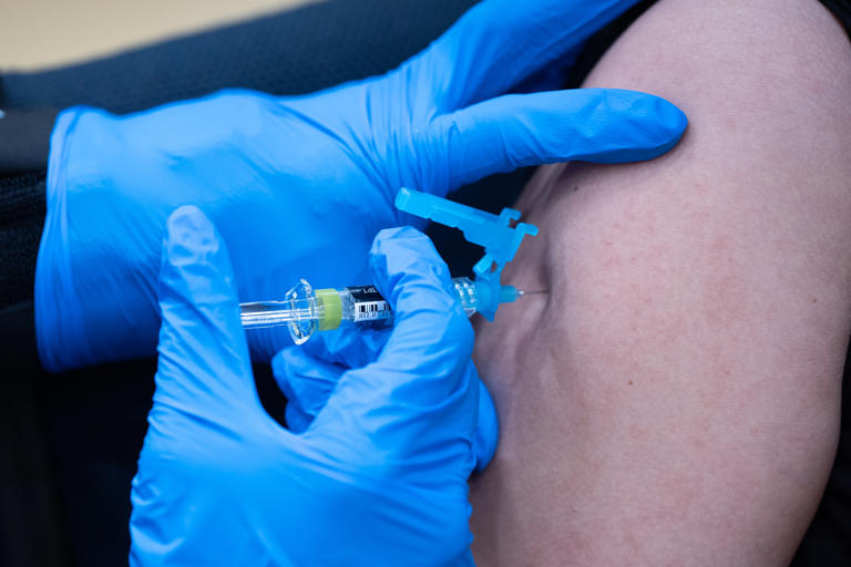 A student is vaccinated at a clinic in Bowie, Maryland.