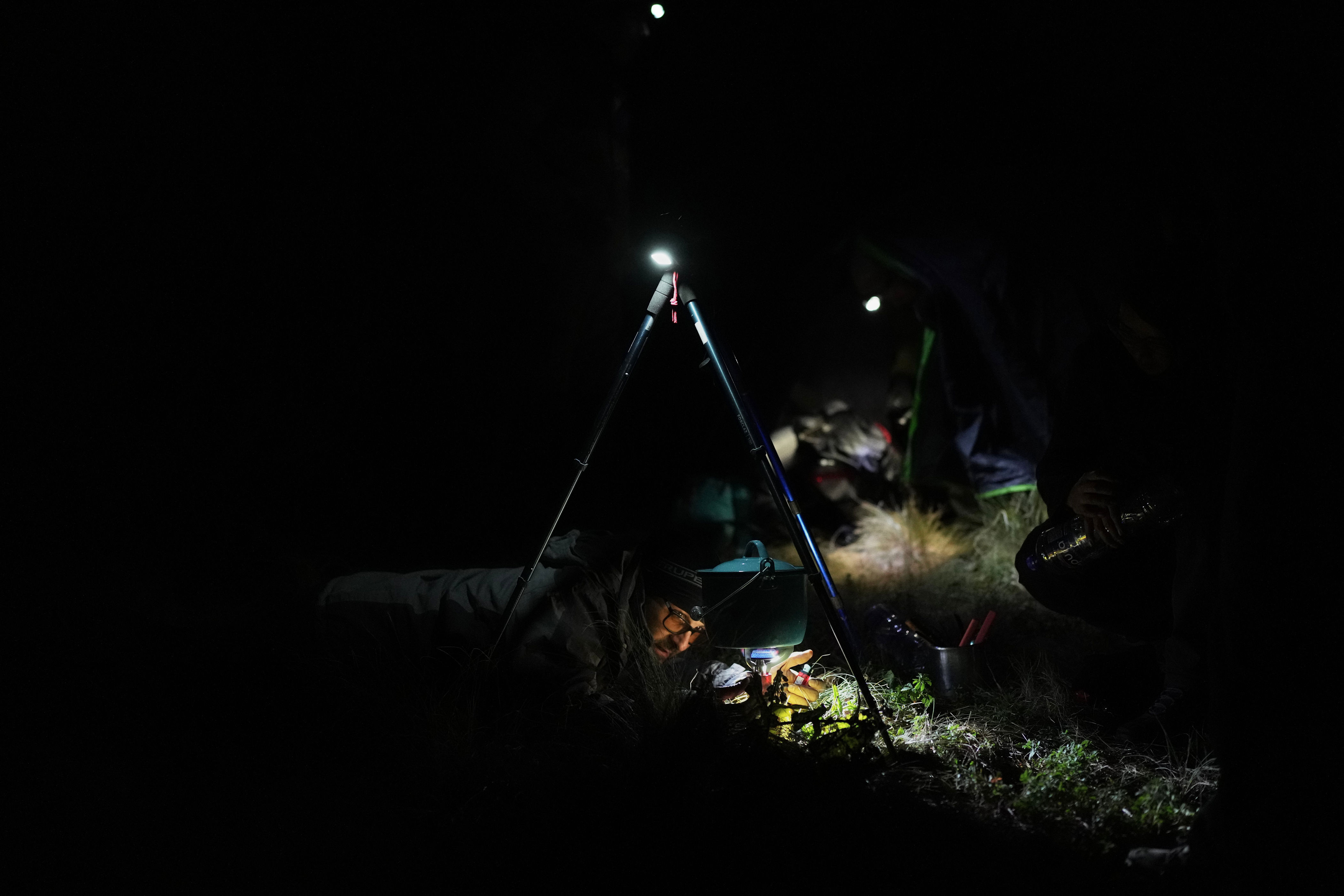 Marco Calo, a geophysicist at the National Autonomous University of Mexico (UNAM), prepares food at the campsite on the slopes of the Popocatepetl volcano, Mexico, Thursday, Dec. 4, 2025. (AP Photo/Eduardo Verdugo) (Copyright 2025 The Associated Press. All rights reserved.)