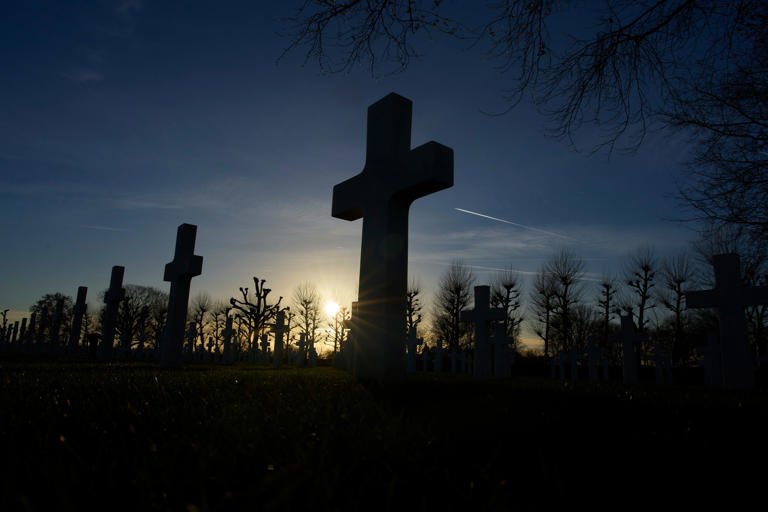 The sun sets over the graves of more than 8.300 WWII soldiers at the Netherlands American Cemetery in Margraten, Netherlands, Thursday, Dec. 11, 2025, where the American Battle Monuments Commission removed two displays honoring Black liberators from the visitors center. (AP Photo/Peter Dejong) (Copyright 2025 The Associated Press. All rights reserved)