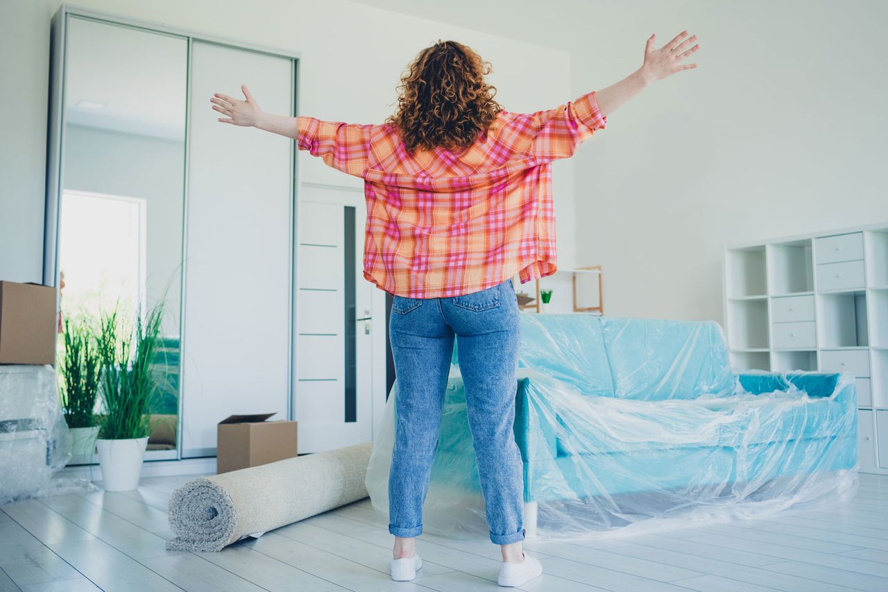 Photo of positive lovely cute adorable woman buy new flat apartment real estate restoration repair indoors.