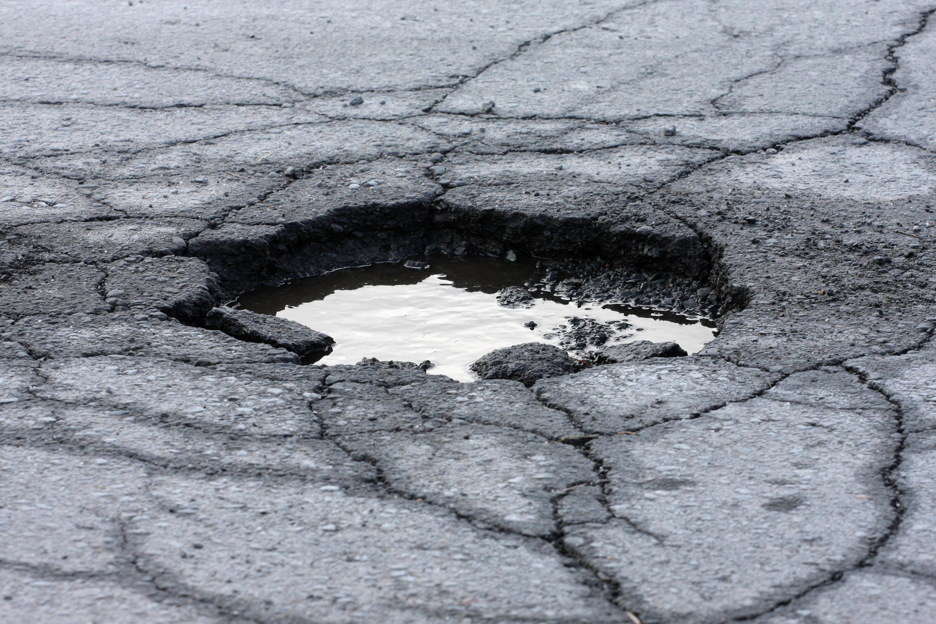 Potholes wreak havoc as LA halts street repaving, opts for patching