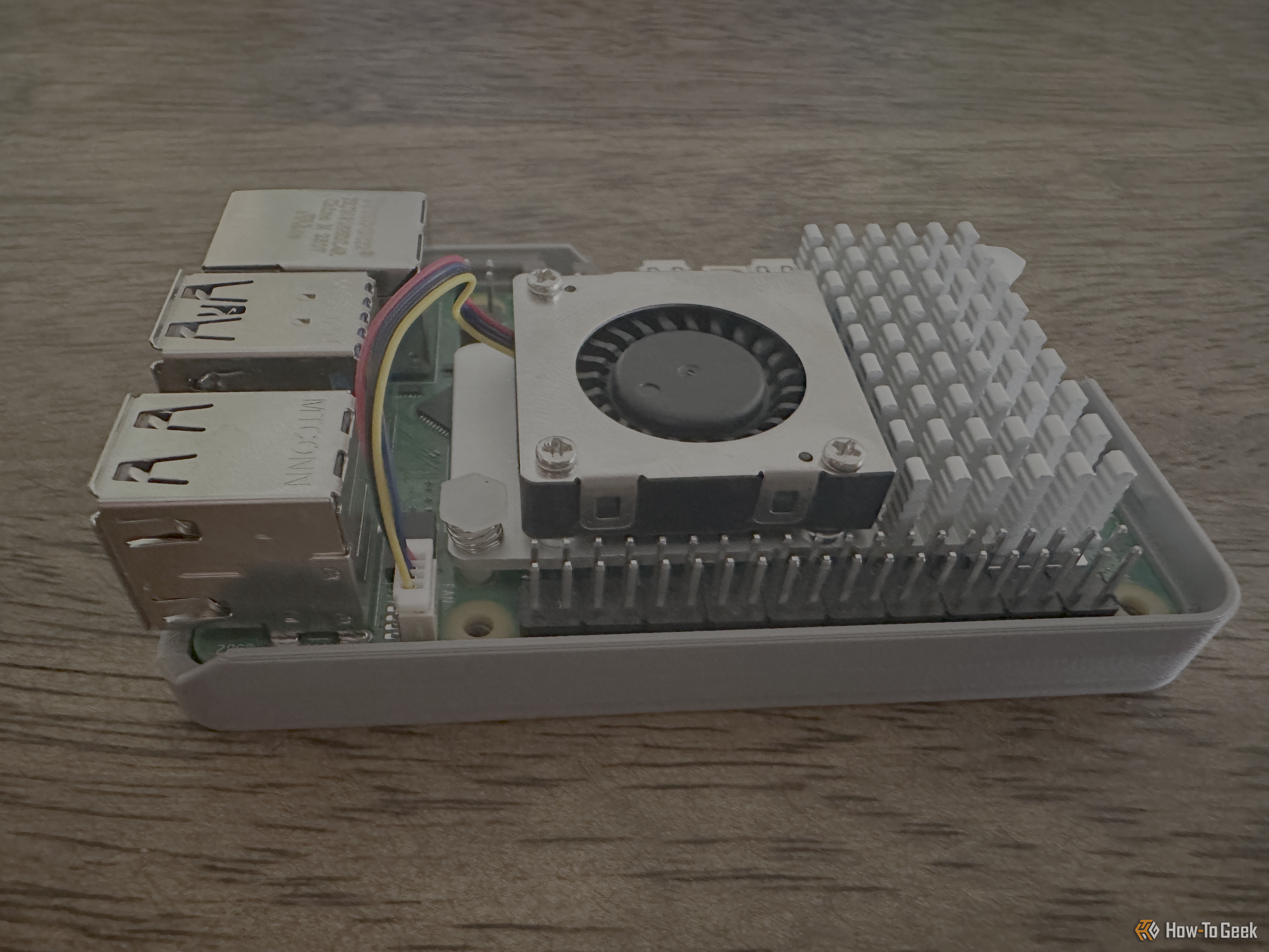 A Raspberry Pi 5 fitted with an active cooler in the bottom half of a case.