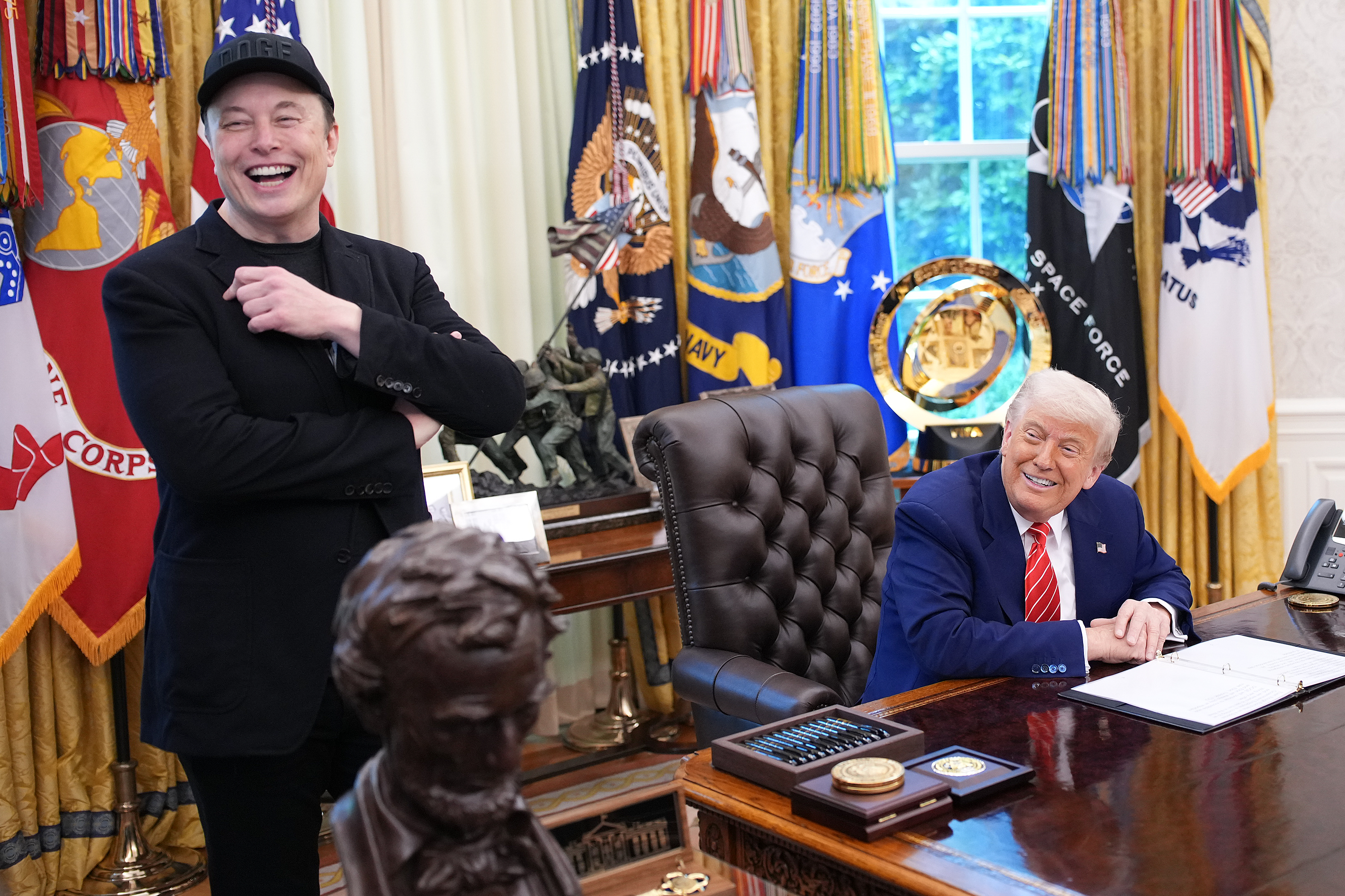 Tesla CEO Elon Musk and U.S. President Donald Trump laugh as they listen to a question from reporters in the Oval Office of the White House on May 30, 2025, in Washington, D.C. (Kevin Dietsch/Getty Images)