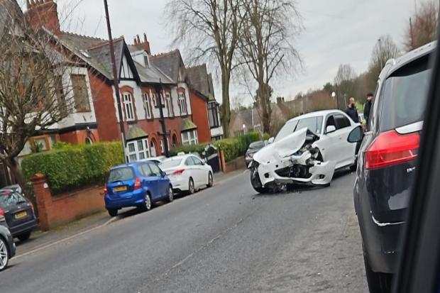 Wreckage strewn across the road following crash on busy road