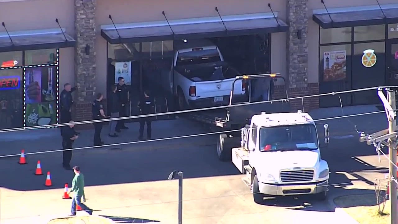 Sky 5 shows aftermath of pickup truck crashing into Great Clips in ...