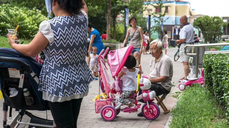 Children play in a residential community in Beijing in 2015. - Zhang Peng/LightRocket/Getty Images