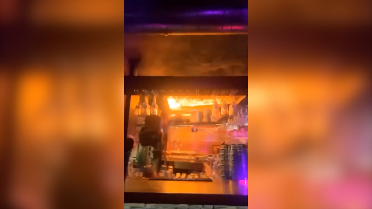 Terrifying moment fire spreads through ceiling of Swiss ski resort bar
