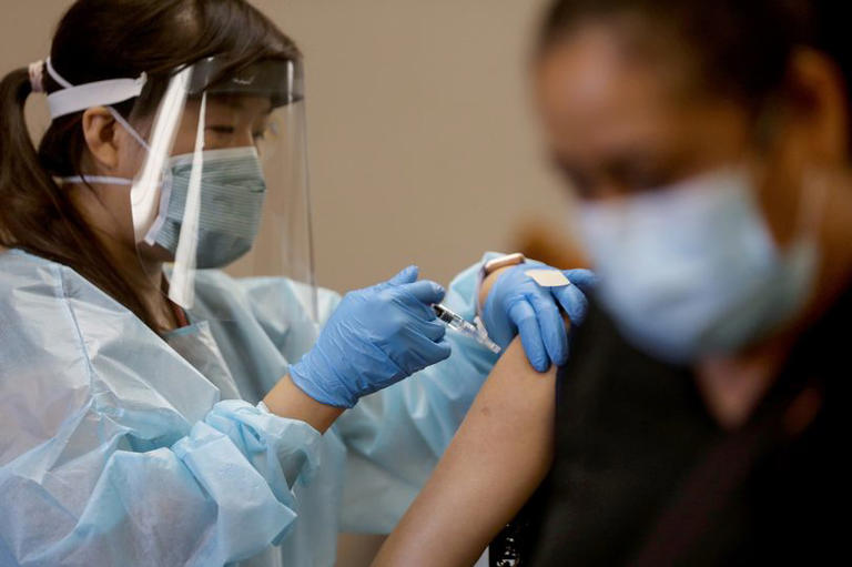 Flu surges across US, hospitals overwhelmed as doctors warn peak is far off