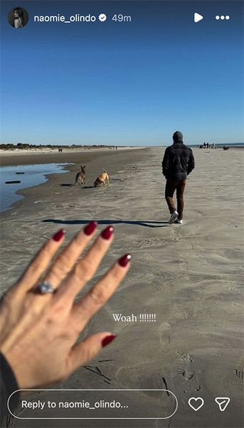 Naomie Olindo showing off her engagement ring while walking outside.