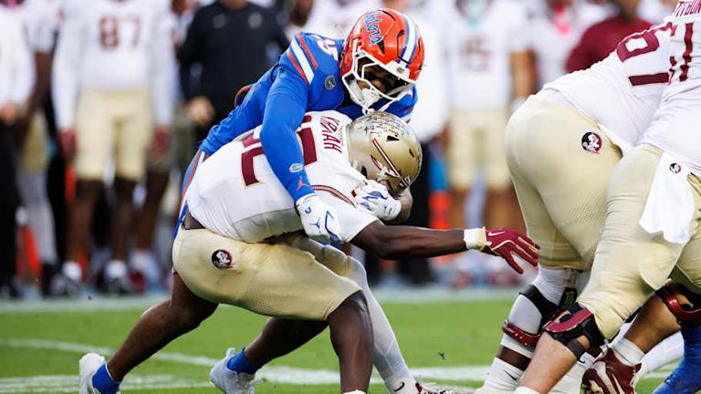 Florida Gators defensive lineman Jayden Woods (15) tackles Florida State Seminoles running back Ousmane Kromah (32) | Matt Pendleton-Imagn Images
