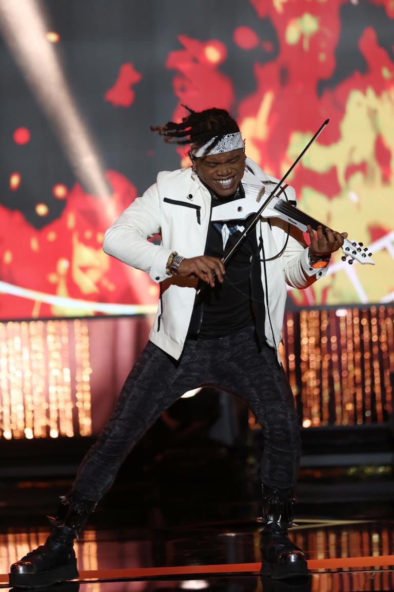 Electric violinist Brian King Joseph, seen performing at an awards show last October, is suing for wrongful termination, retaliation and sexual harassment. ((Tommaso Boddi / Getty Images for Media Access Awards))